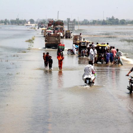 Mandatory Credit: Photo by WAQAR HUSSEIN/EPA-EFE/Shutterstock (13353128d)

People cross a flooded highway in Dadu district, Sindh province, Pakistan, 30 August 2022. According to the National Disaster Management Authority (NDMA) on 27 August, flash floods triggered by heavy monsoon rains have killed over 1,000 people across Pakistan since mid-June 2022. More than 33 million people have been affected by floods, the country's climate change minister said.
Over 1,000 dead since June amid heavy monsoon rains in Pakistan, Dadu - 30 Aug 2022