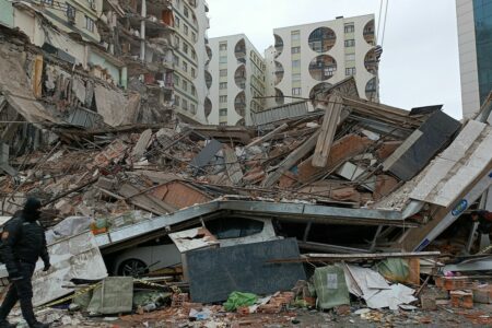 Rescue teams try to reach trapped residents inside collapsed buildings at Galleria Apartment in Diyarbakir, southeast Turkey.