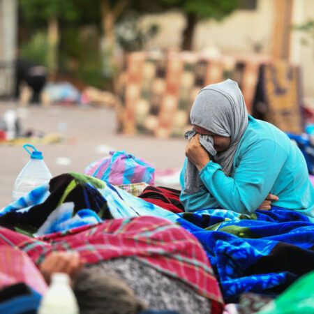 A woman reacts as people sleep on a street following the powerful earthquake in Marrakesh, Morocco on September 10, 2023.